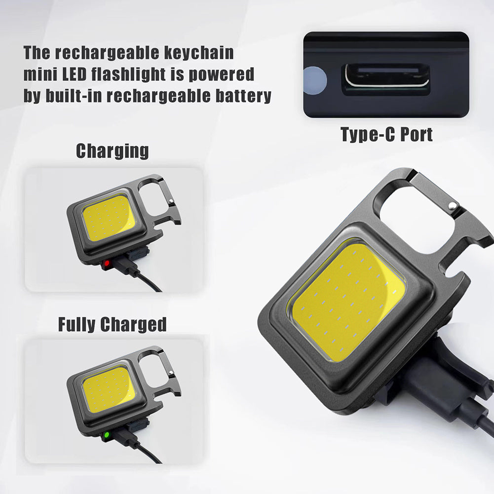 Compact keychain work light shown in hand for scale